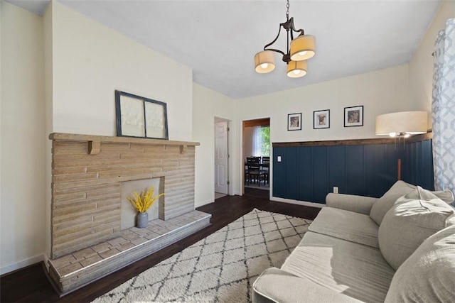 108 Republic Ave, Indiana Twp, PA 15051 - living room with dark wood finished floors, a chandelier, and a brick fireplace