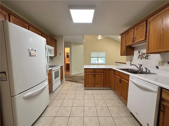 1009 Ironwood Cir, Jeannette, PA 15644 - kitchen featuring white appliances, a peninsula, brown cabinets, light tile patterned flooring, and light countertops