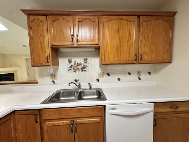 1009 Ironwood Cir, Jeannette, PA 15644 - kitchen with dishwasher, decorative backsplash, light countertops, brown cabinetry, and a fireplace