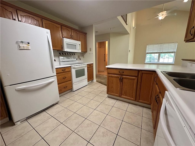 1009 Ironwood Cir, Jeannette, PA 15644 - kitchen with white appliances, brown cabinetry, light tile patterned floors, and light countertops