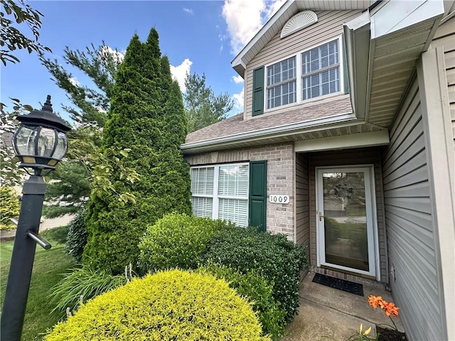 1009 Ironwood Cir, Jeannette, PA 15644 - doorway to property with brick siding and a shingled roof