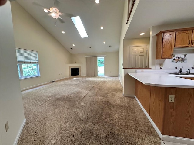 1009 Ironwood Cir, Jeannette, PA 15644 - unfurnished living room with light colored carpet, a skylight, recessed lighting, high vaulted ceiling, and a fireplace