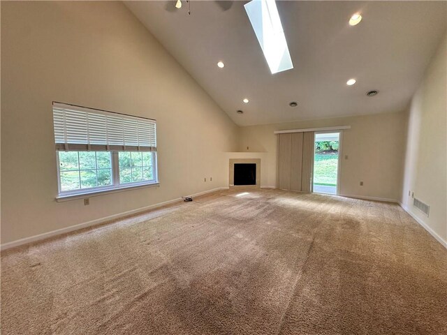 1009 Ironwood Cir, Jeannette, PA 15644 - unfurnished living room featuring plenty of natural light, recessed lighting, carpet, a fireplace, and a skylight