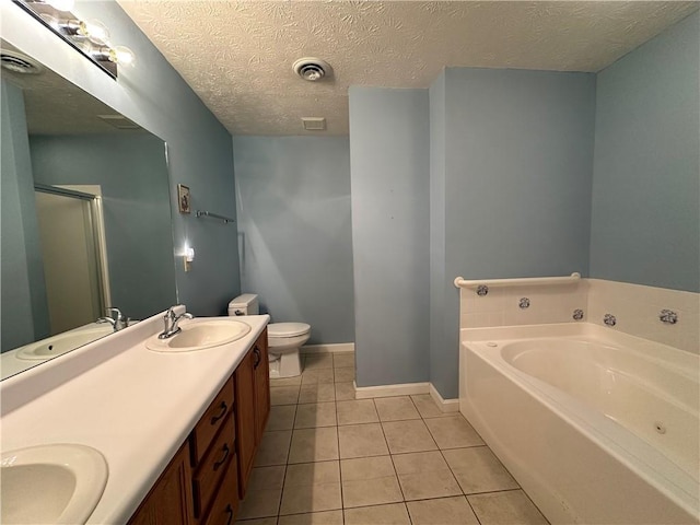 1009 Ironwood Cir, Jeannette, PA 15644 - bathroom featuring a garden tub, tile patterned flooring, double vanity, a shower stall, and a textured ceiling