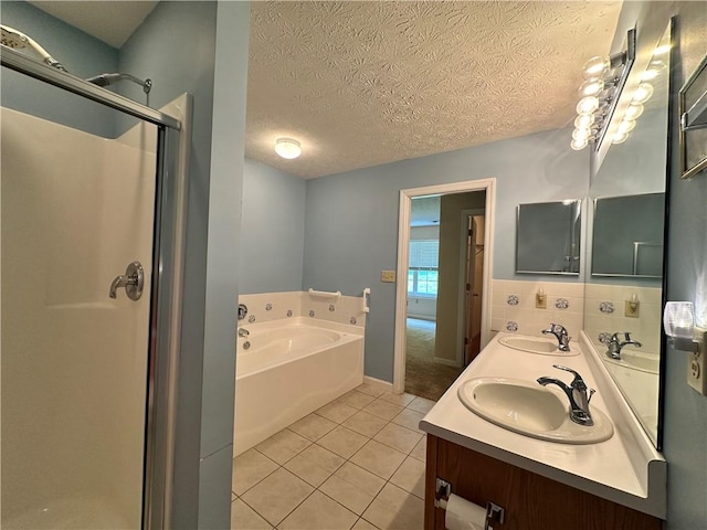 1009 Ironwood Cir, Jeannette, PA 15644 - bathroom with tile patterned floors, a shower stall, a bath, double vanity, and a textured ceiling