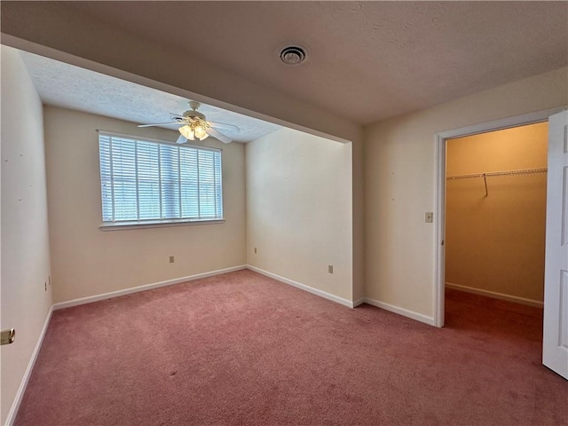 1009 Ironwood Cir, Jeannette, PA 15644 - unfurnished bedroom with carpet, a walk in closet, a closet, ceiling fan, and a textured ceiling