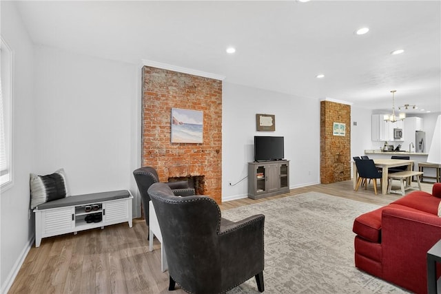 4536 Friendship Ave, Bloomfield, PA 15224 - living room featuring a chandelier, light wood-style floors, a fireplace, and recessed lighting
