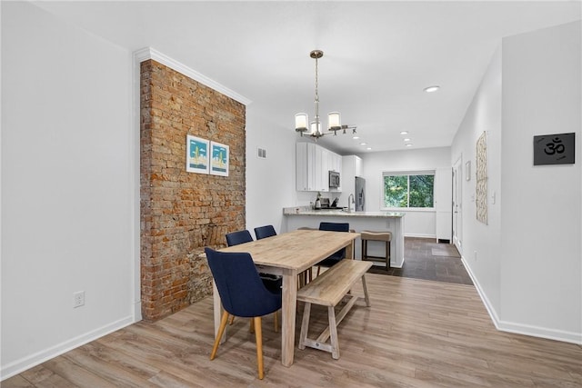 4536 Friendship Ave, Bloomfield, PA 15224 - dining area featuring a chandelier, wood finished floors, and recessed lighting
