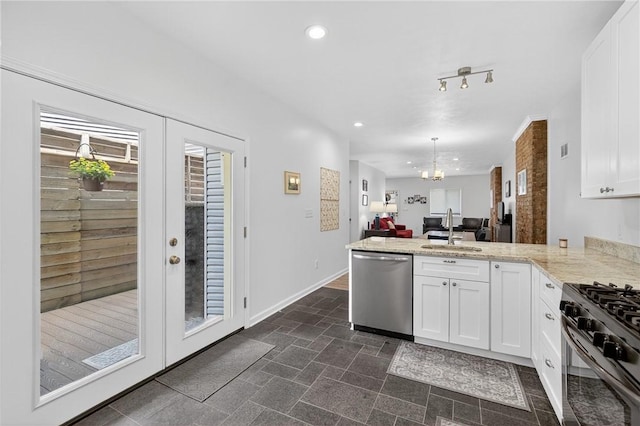 4536 Friendship Ave, Bloomfield, PA 15224 - kitchen featuring dishwasher, a peninsula, range with gas stovetop, open floor plan, and white cabinetry