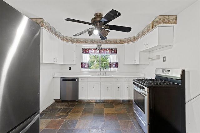 242 Millport Rd, West Mifflin, PA 15122 - kitchen with stainless steel appliances, stone tile floors, white cabinetry, and ceiling fan