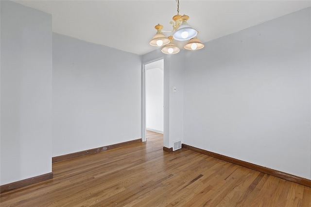 242 Millport Rd, West Mifflin, PA 15122 - spare room with a chandelier and wood finished floors