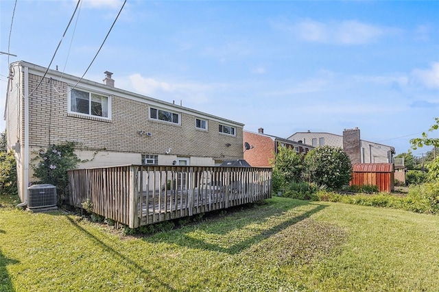 242 Millport Rd, West Mifflin, PA 15122 - rear view of property featuring brick siding, a lawn, a wooden deck, and a chimney