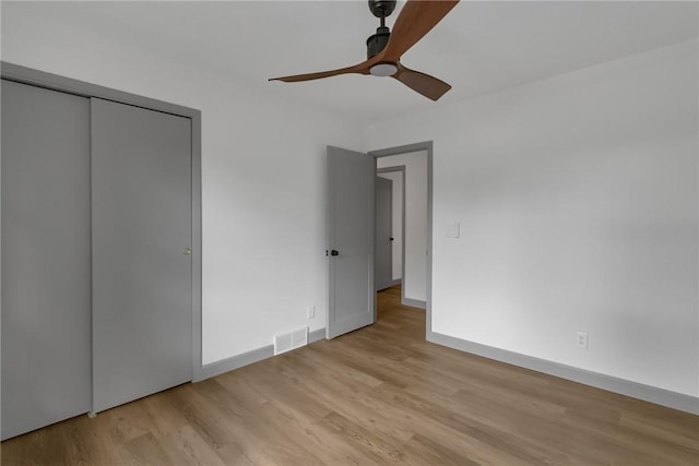231 W Shaffer Rd, Center Twp, PA 15001 - unfurnished bedroom featuring light wood-style floors, a ceiling fan, and a closet