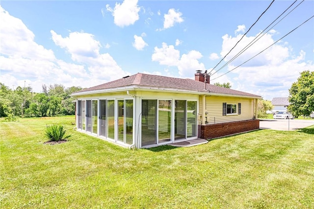 1515 George St, Unity Twp, PA 15650 - rear view of property with a chimney, a lawn, and a sunroom