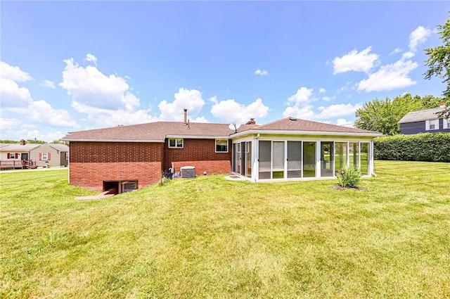 1515 George St, Unity Twp, PA 15650 - back of house featuring brick siding, a sunroom, and a yard