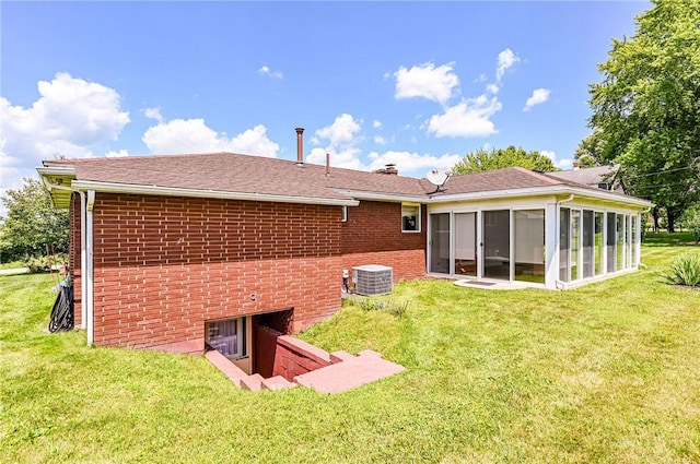 1515 George St, Unity Twp, PA 15650 - rear view of property with a sunroom, brick siding, a yard, and a chimney