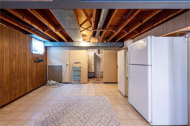 1515 George St, Unity Twp, PA 15650 - below grade area featuring freestanding refrigerator, light flooring, and wooden walls