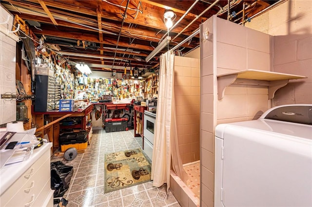 1515 George St, Unity Twp, PA 15650 - unfinished below grade area with washer / dryer, a workshop area, and light flooring