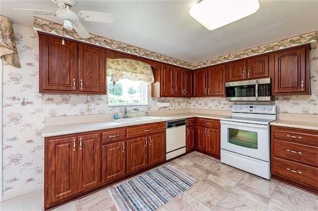 1515 George St, Unity Twp, PA 15650 - kitchen with white appliances, wallpapered walls, light countertops, and ceiling fan