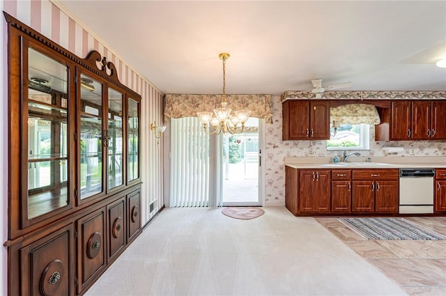 1515 George St, Unity Twp, PA 15650 - kitchen featuring white dishwasher, a chandelier, light countertops, wallpapered walls, and hanging light fixtures