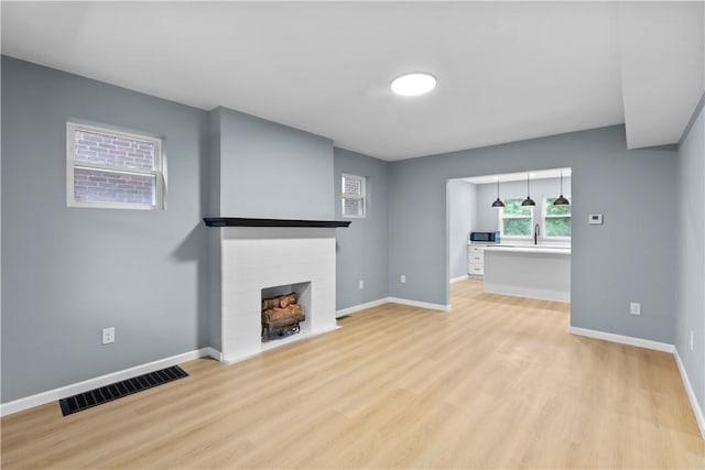 3322 Webster Ave, Schenley Heights, PA 15219 - unfurnished living room with a fireplace and light wood-style floors