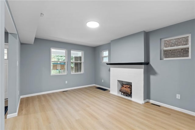 3322 Webster Ave, Schenley Heights, PA 15219 - unfurnished living room with a fireplace and light wood-type flooring