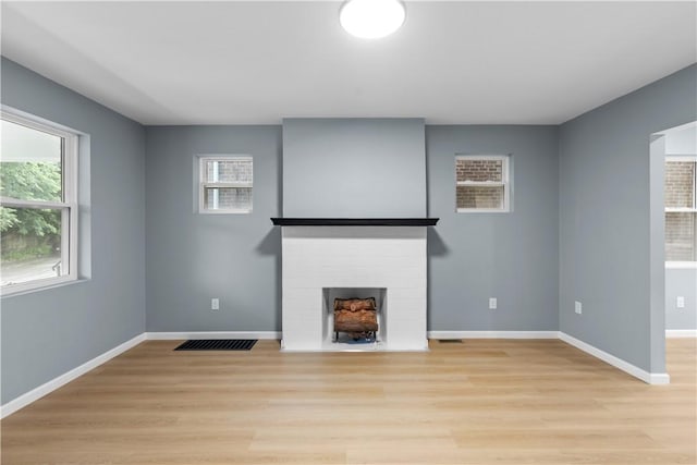 3322 Webster Ave, Schenley Heights, PA 15219 - unfurnished living room with a fireplace with flush hearth, light wood-style floors, and plenty of natural light