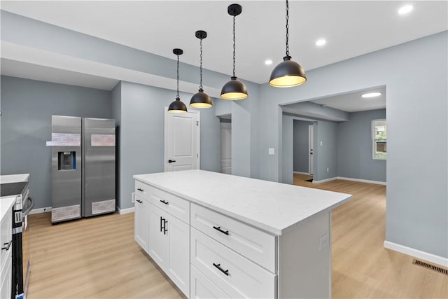 3322 Webster Ave, Schenley Heights, PA 15219 - kitchen with stainless steel fridge with ice dispenser, light wood-type flooring, pendant lighting, light countertops, and white cabinets