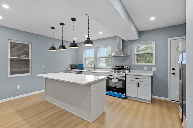 3322 Webster Ave, Schenley Heights, PA 15219 - kitchen featuring appliances with stainless steel finishes, wall chimney exhaust hood, light wood-style flooring, healthy amount of natural light, and recessed lighting