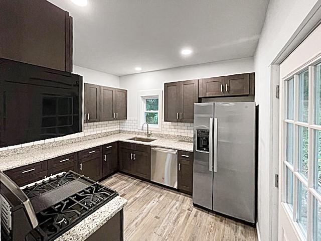 1713 Belasco Ave, Beechview, PA 15216 - kitchen with appliances with stainless steel finishes, dark brown cabinets, decorative backsplash, light wood-style flooring, and recessed lighting