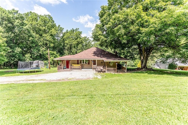 132 Spaugy Hollow Rd, Bullskin Twp, PA 15425 - view of front of property featuring covered porch, a trampoline, a front yard, and driveway