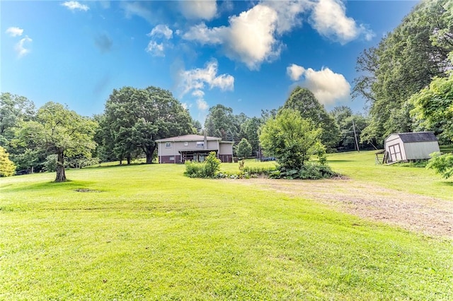132 Spaugy Hollow Rd, Bullskin Twp, PA 15425 - view of grassy yard featuring a shed and view of wooded area