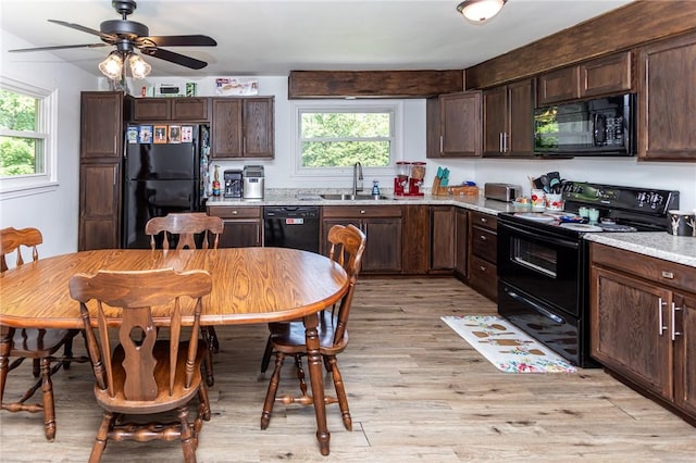 132 Spaugy Hollow Rd, Bullskin Twp, PA 15425 - kitchen featuring black appliances, plenty of natural light, light wood-style flooring, and dark brown cabinets