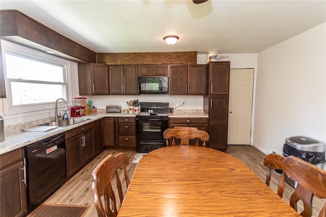132 Spaugy Hollow Rd, Bullskin Twp, PA 15425 - kitchen with black appliances, light wood-style floors, dark brown cabinets, and light countertops