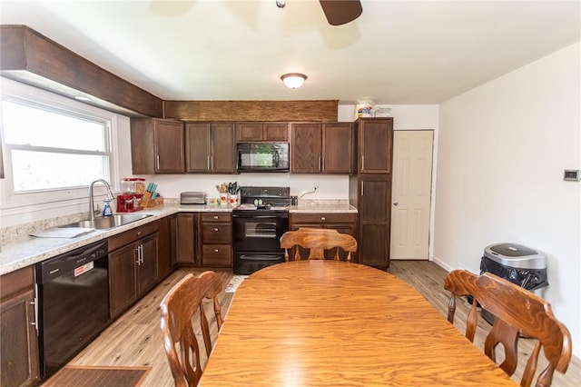 132 Spaugy Hollow Rd, Bullskin Twp, PA 15425 - kitchen with black appliances, light wood-style floors, dark brown cabinetry, light countertops, and ceiling fan