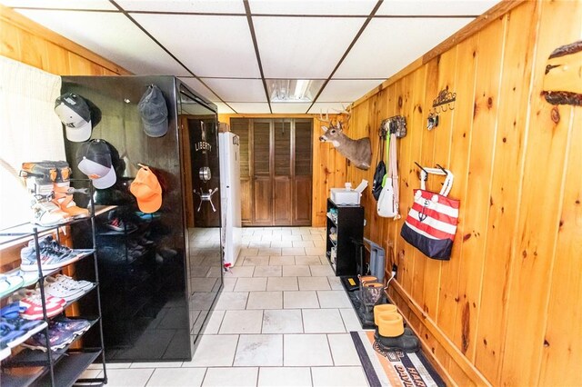 132 Spaugy Hollow Rd, Bullskin Twp, PA 15425 - mudroom with a paneled ceiling, tile patterned floors, and wooden walls