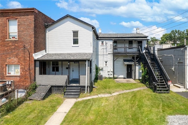 613-615 W Main St, Carnegie, PA 15106 - townhome / multi-family property with brick siding, stairs, a front yard, and covered porch