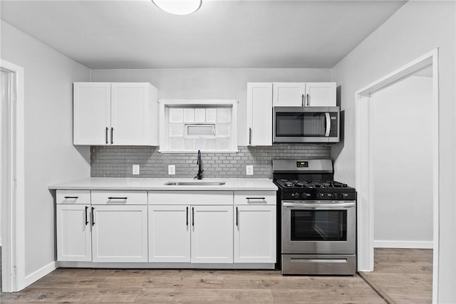 613-615 W Main St, Carnegie, PA 15106 - kitchen featuring stainless steel appliances, white cabinets, light countertops, and decorative backsplash