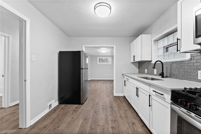613-615 W Main St, Carnegie, PA 15106 - kitchen with stainless steel appliances, light countertops, tasteful backsplash, and wood finished floors