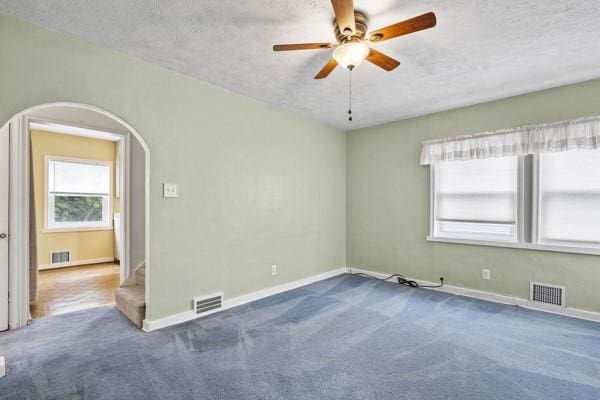 110 5th Ave, Ross Twp, PA 15229 - carpeted spare room featuring a textured ceiling, arched walkways, and ceiling fan