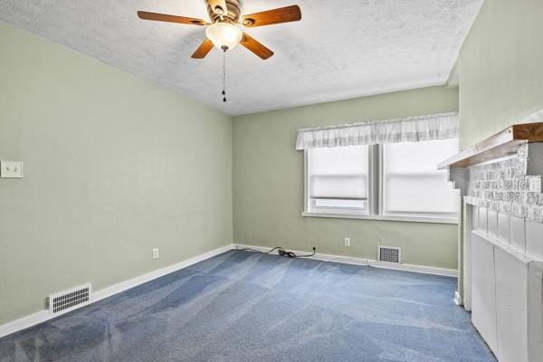 110 5th Ave, Ross Twp, PA 15229 - unfurnished living room featuring a fireplace, a textured ceiling, carpet, and ceiling fan