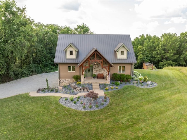 2780 Ipnar Rd, North Huntingdon, PA 15642 - view of front of house featuring stone siding, covered porch, a front yard, a storage shed, and a metal roof