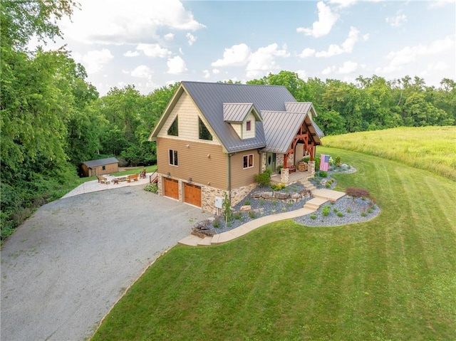 2780 Ipnar Rd, North Huntingdon, PA 15642 - view of front of property with an attached garage, stone siding, covered porch, gravel driveway, and a front yard