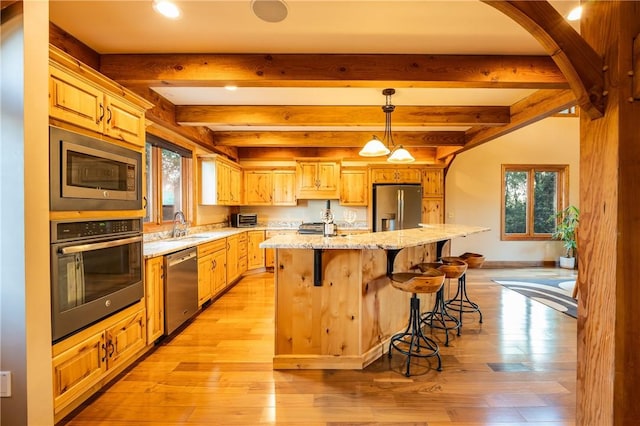 2780 Ipnar Rd, North Huntingdon, PA 15642 - kitchen with stainless steel appliances, an island with sink, recessed lighting, light wood-type flooring, and light stone counters