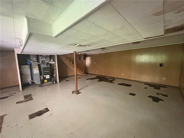 270 Wheeler Ave, Stowe Twp, PA 15136 - finished below grade area featuring gas water heater, a paneled ceiling, stairs, tile patterned floors, and wooden walls