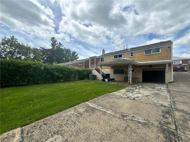 270 Wheeler Ave, Stowe Twp, PA 15136 - back of property featuring an attached garage, a lawn, driveway, brick siding, and a chimney