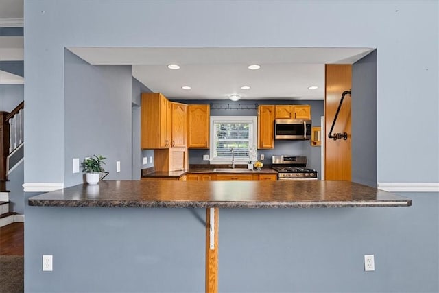 224 Bronx Ave, West View, PA 15229 - kitchen featuring stainless steel appliances, dark countertops, a peninsula, recessed lighting, and brown cabinetry