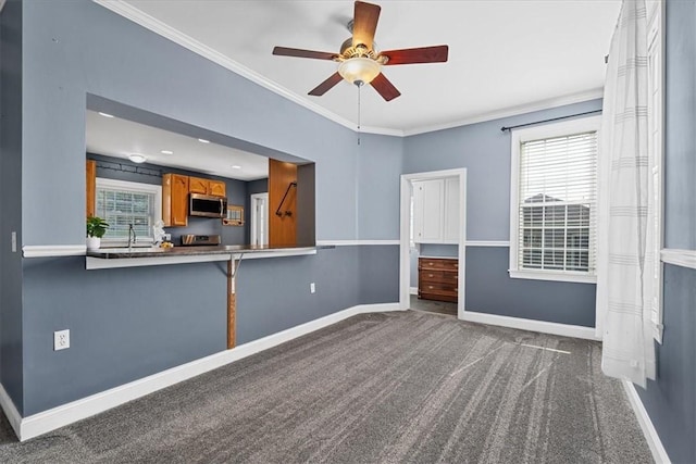 224 Bronx Ave, West View, PA 15229 - unfurnished living room with dark carpet, crown molding, a ceiling fan, and healthy amount of natural light