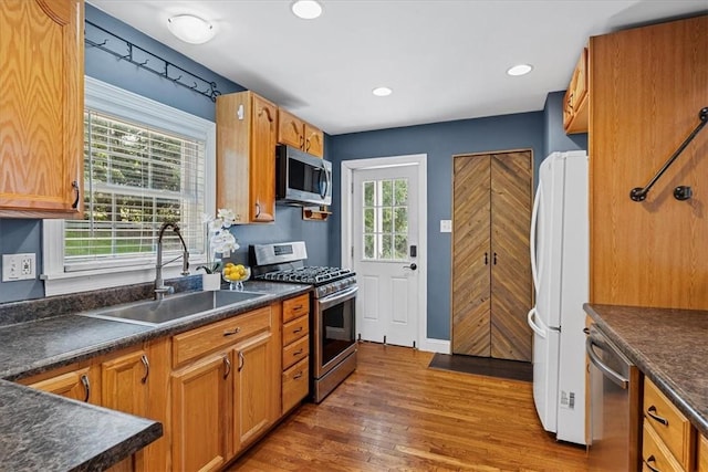224 Bronx Ave, West View, PA 15229 - kitchen with appliances with stainless steel finishes, dark countertops, dark wood-style flooring, brown cabinetry, and recessed lighting