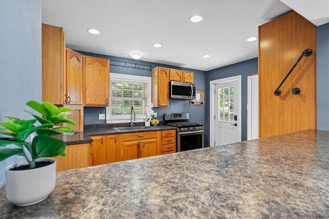 224 Bronx Ave, West View, PA 15229 - kitchen with appliances with stainless steel finishes, recessed lighting, dark countertops, and brown cabinetry